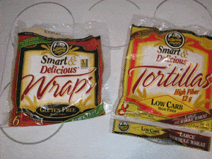A package of gluten free wraps next to a package of low carb wraps.