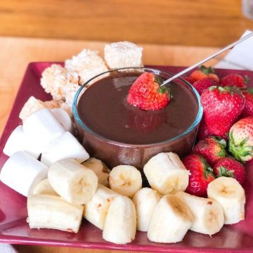 Dairy-free chocolate fondue surrounded by dippers