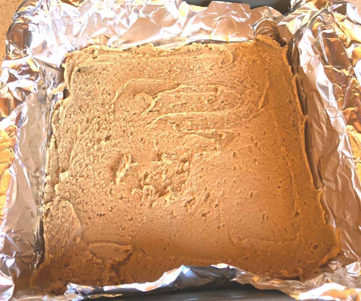 A layer of sunflower butter fudge spread in a pan.