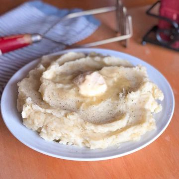 A bowl of mashed potatoes without milk topped with dairy free margarine