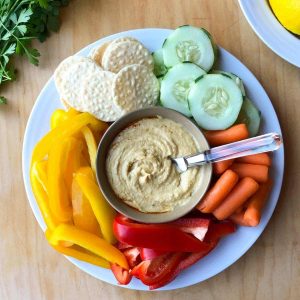 Gluten free hummus on a platter with vegetables