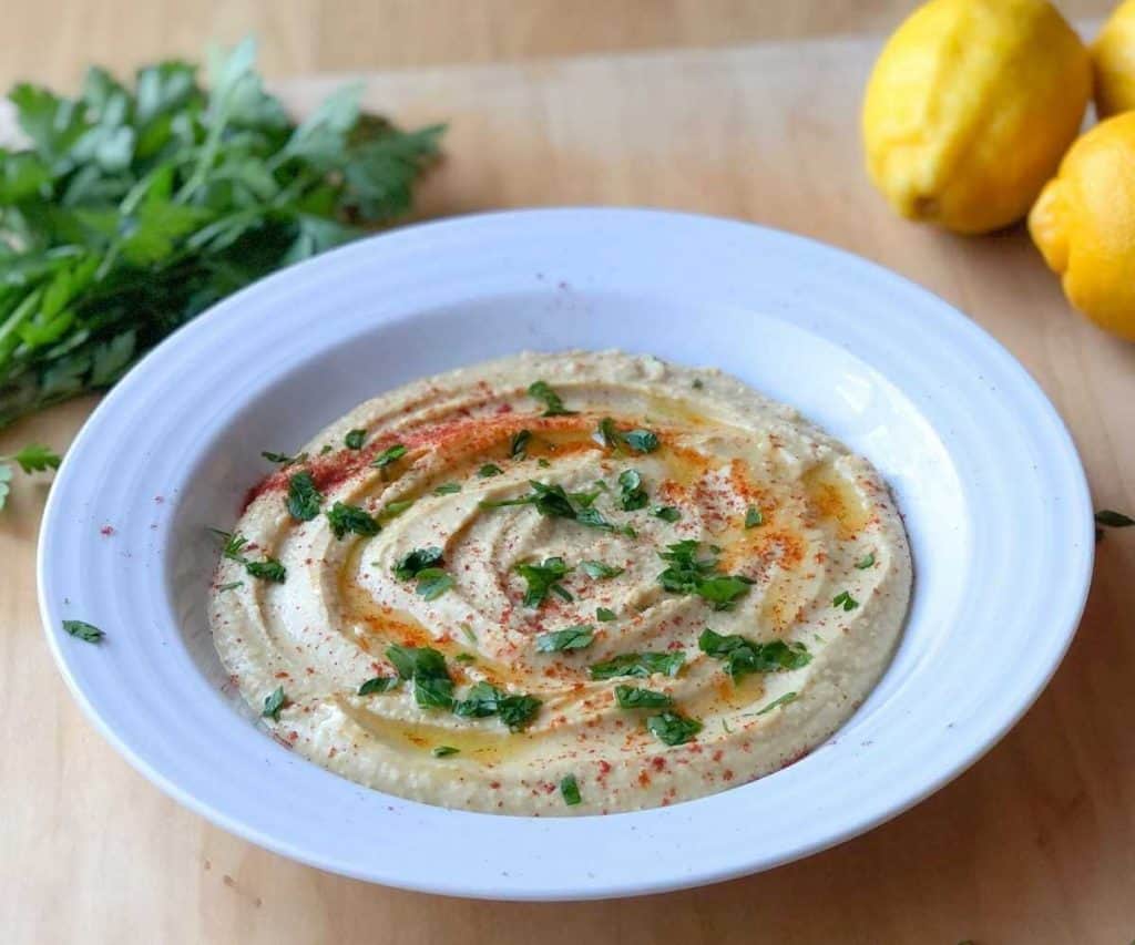 Gluten free hummus garnished with paprika and chopped parsley