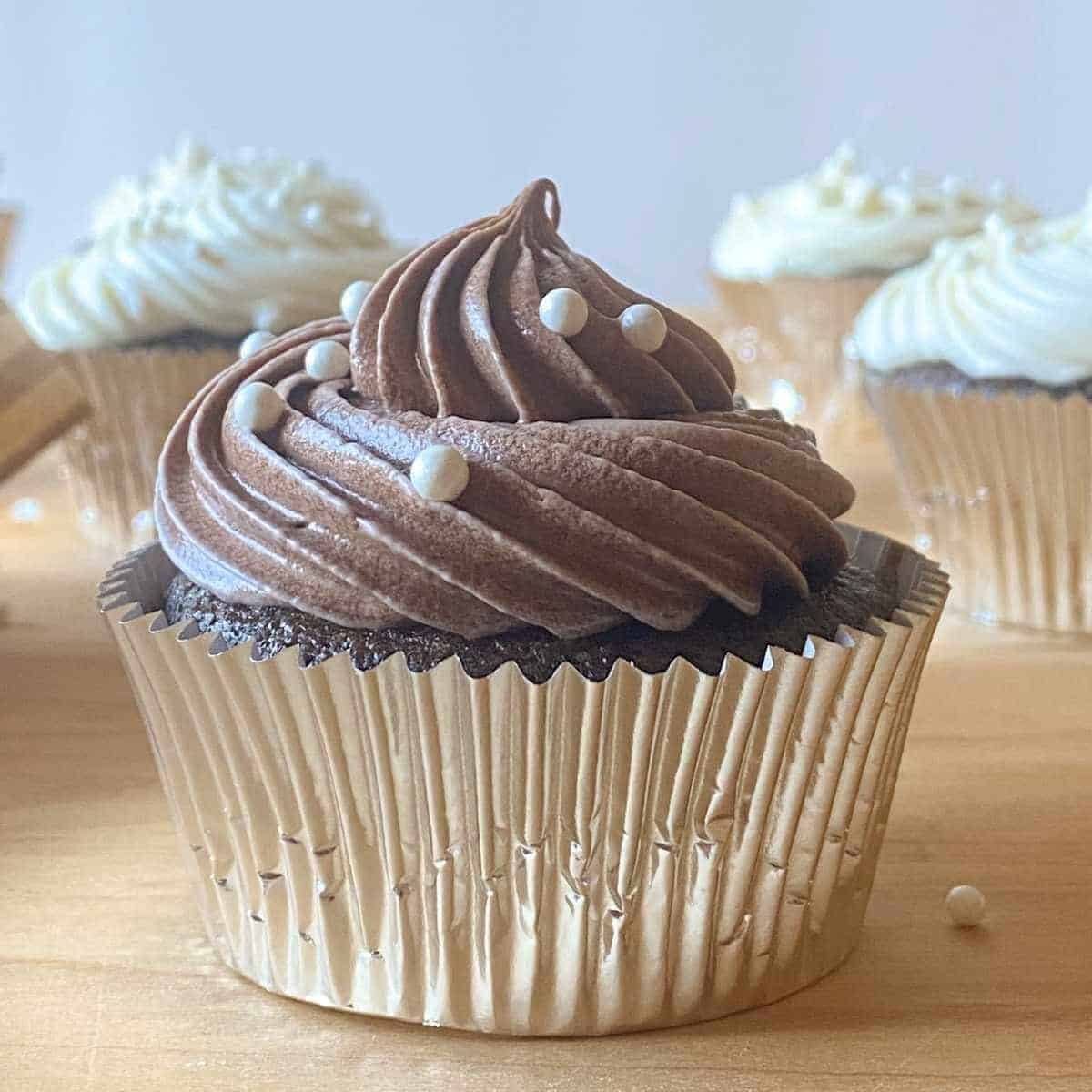 A chocolate gluten free cupcake with chocolate frosting.