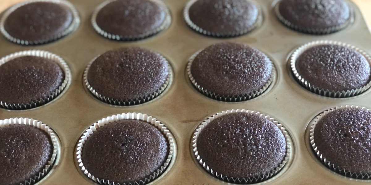 Chocolate gluten free cupcakes in the cupcake tin.