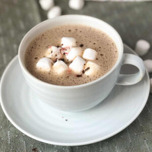 A cup of oat milk hot chocolate with marshmallows