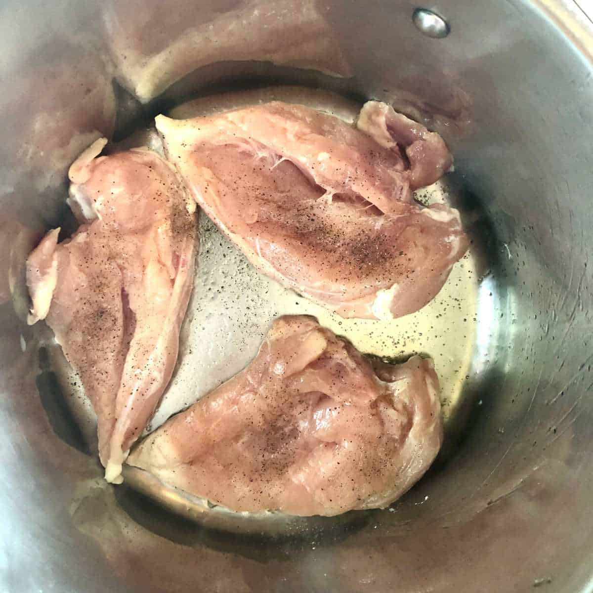 Chicken breasts in a stock pot
