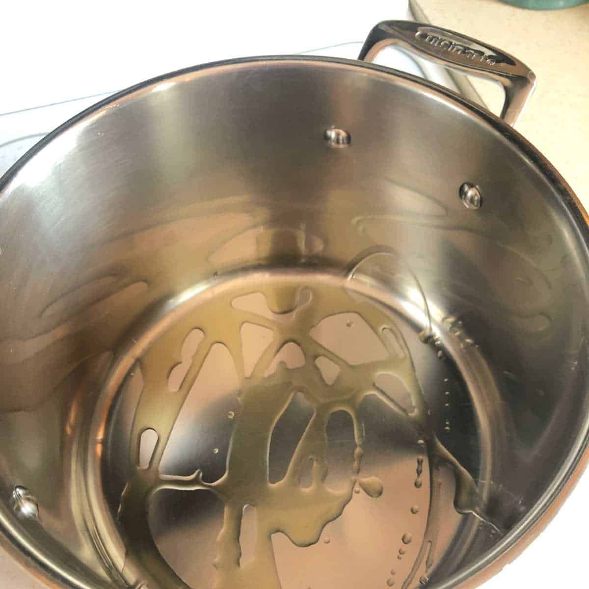 olive oil heating in a stock pot