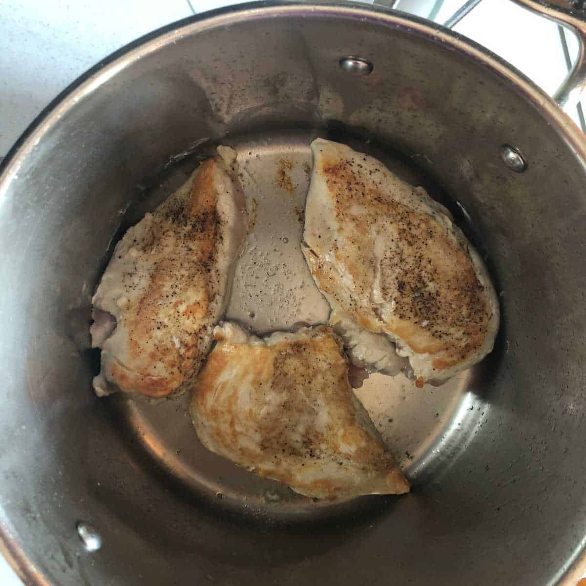 Cooking chicken breasts in a large stock pot