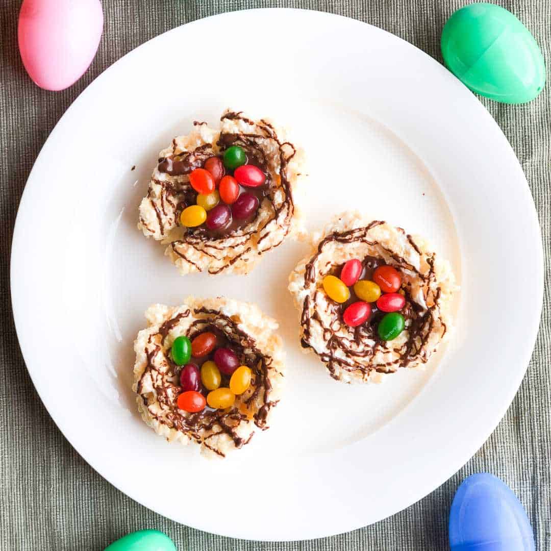 dairy free rice krispie treats formed into nests and filled with jelly beans