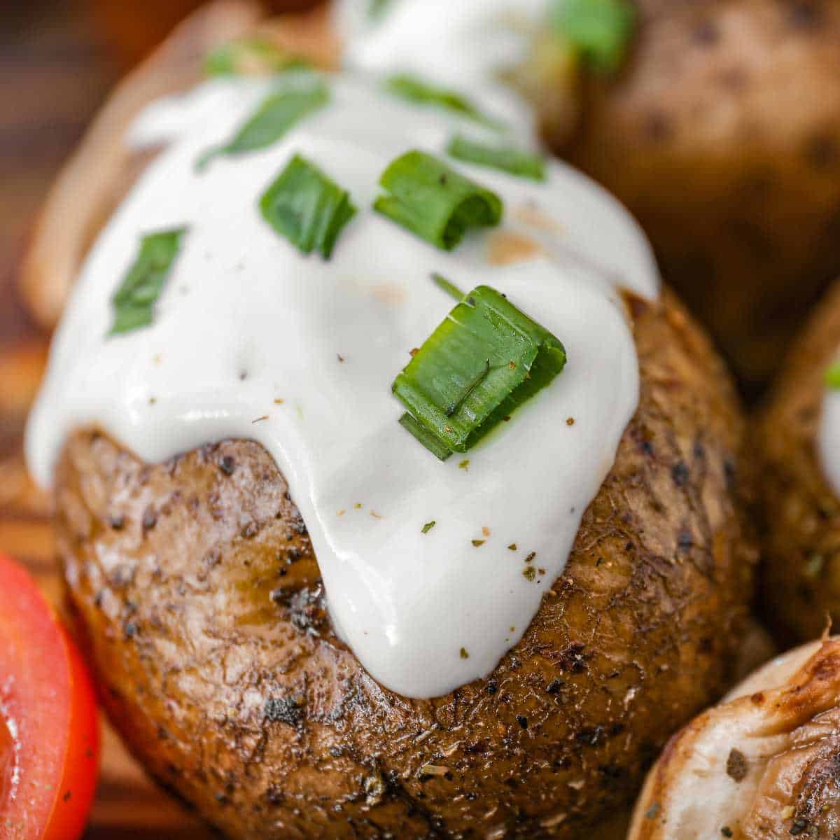 A baked potato with dairy free sour cream