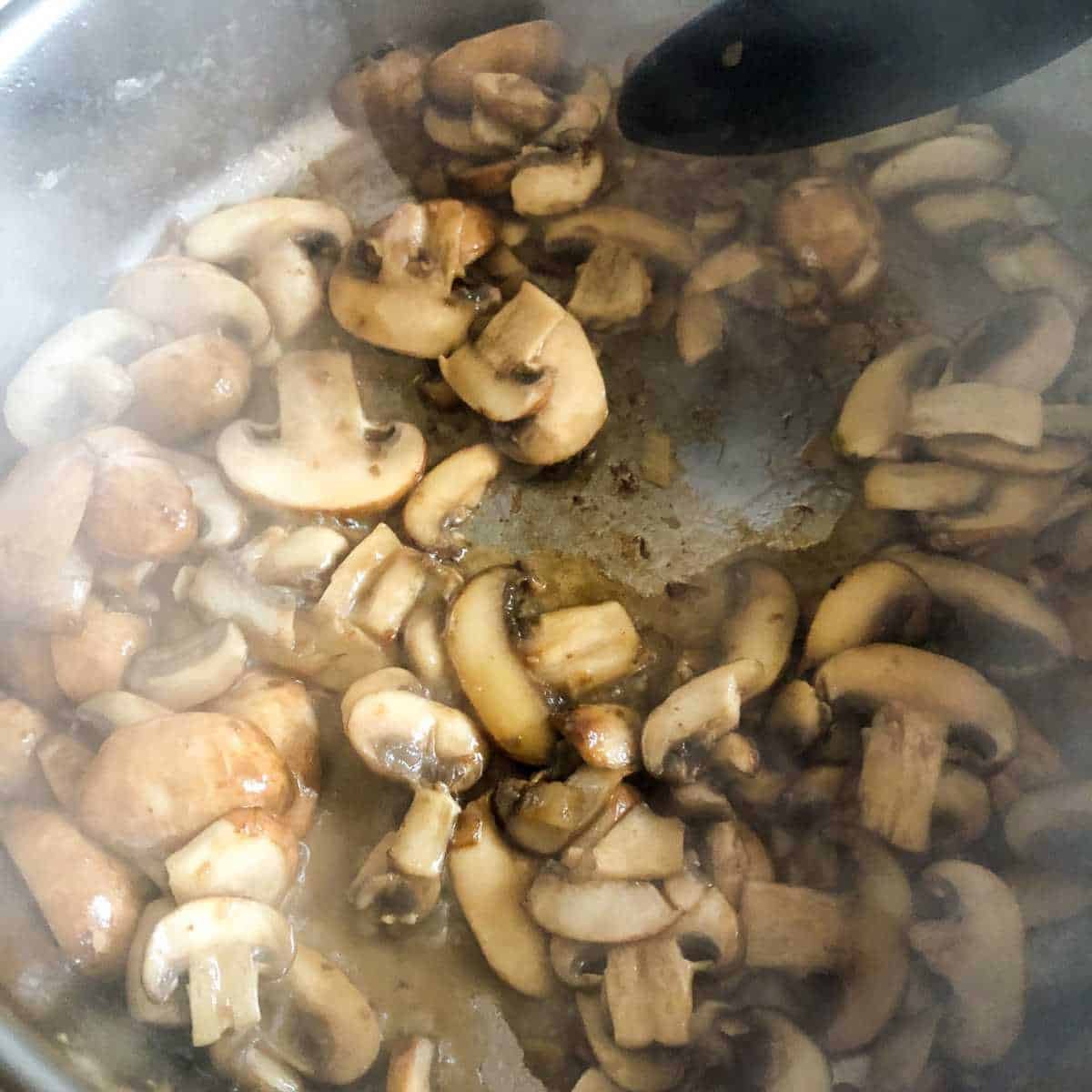 Cooked sliced mushrooms in a skillet