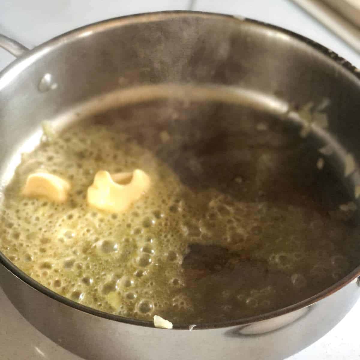 Dairy free butter being melted in a skillet