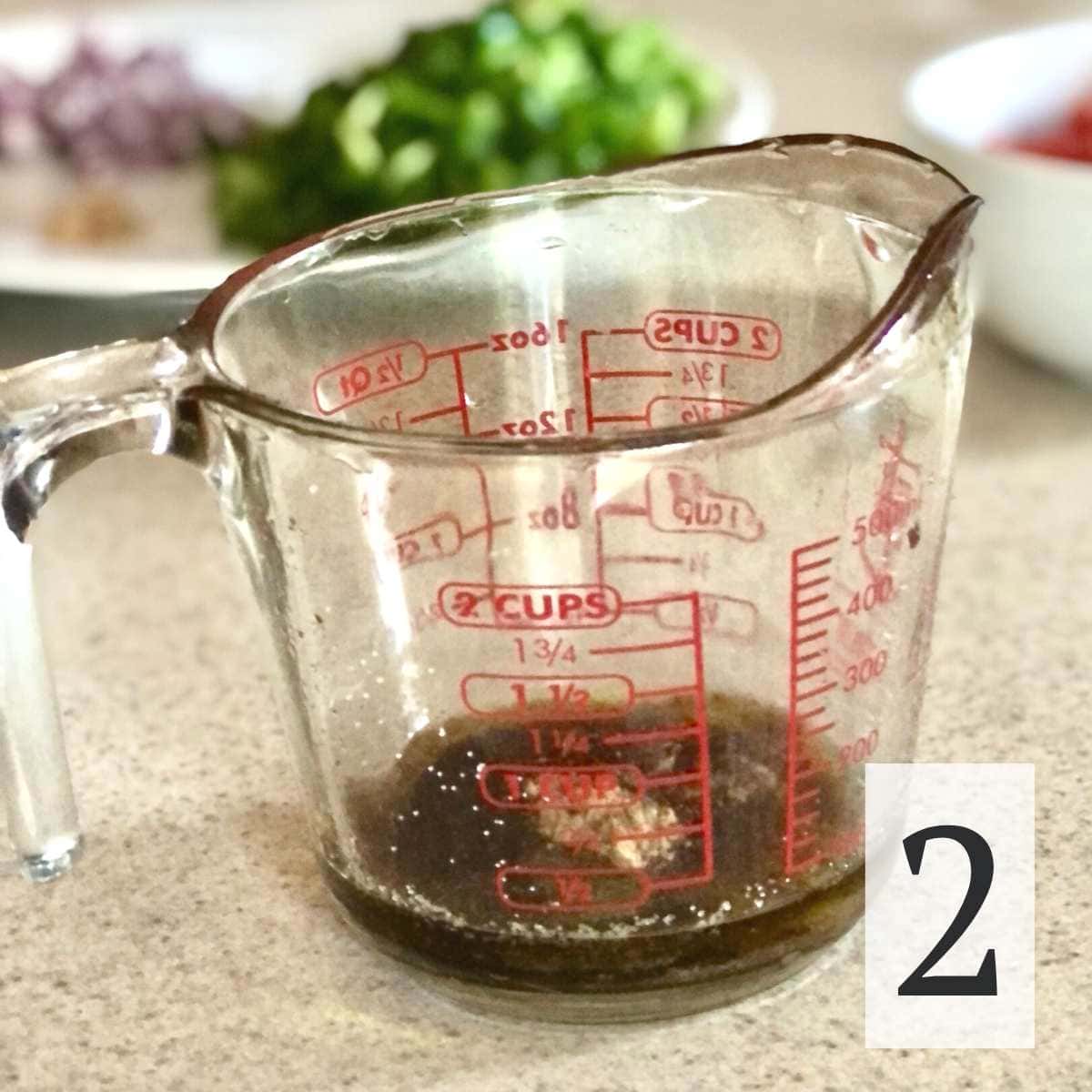 vinegar, lime juice, sugar, cumin, salt, and olive oil in a glass measuring bowl