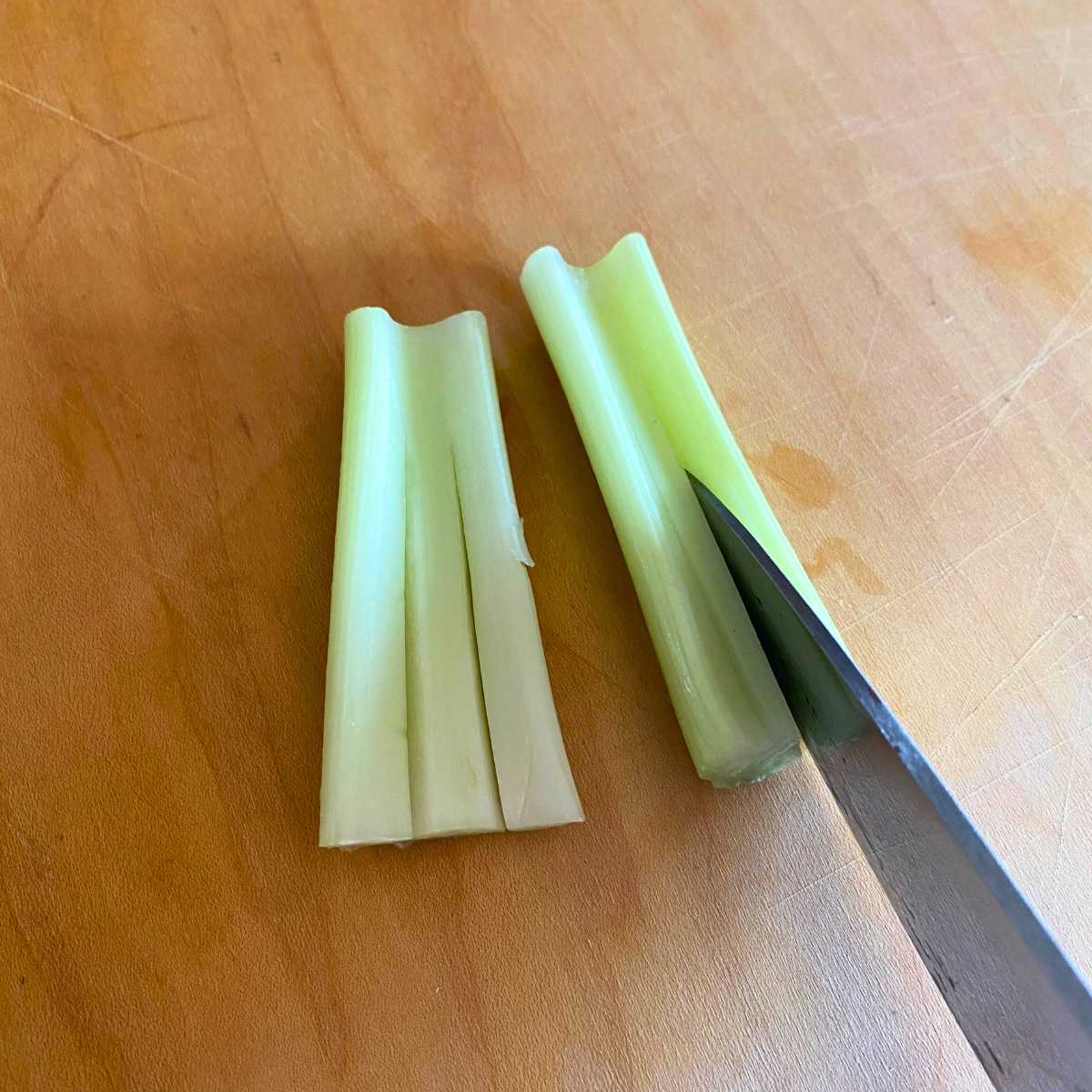 Two short pieces of celery with two slices down the middle to create three sections.