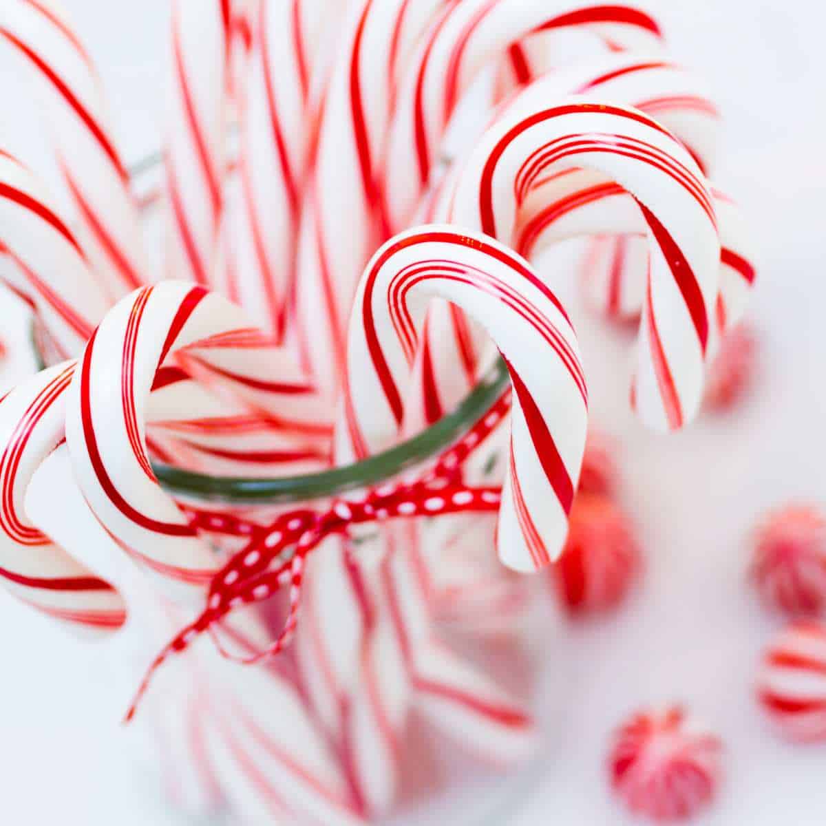 Red and white candy canes in a jar.