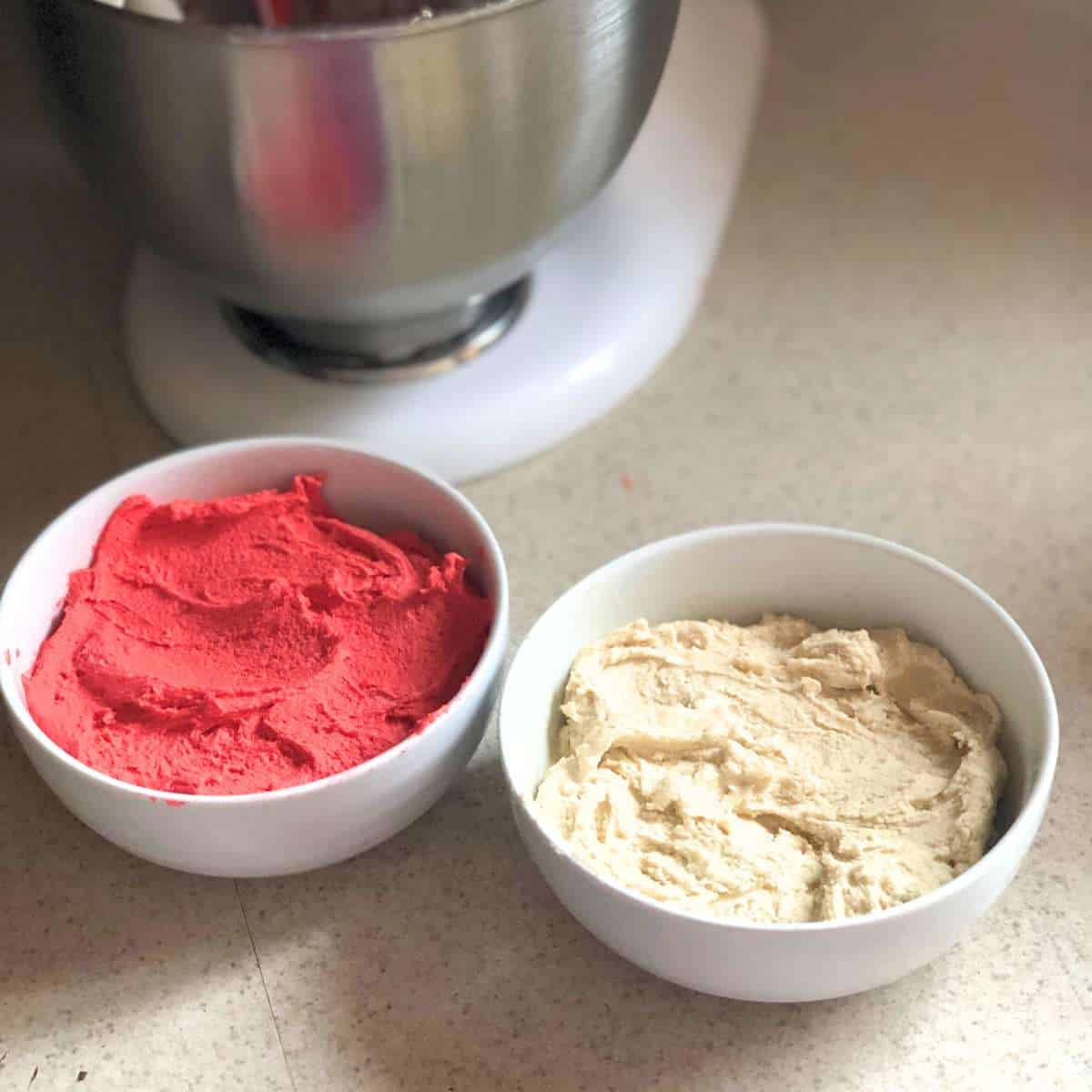 Red and white cookie dough in separate bowls.