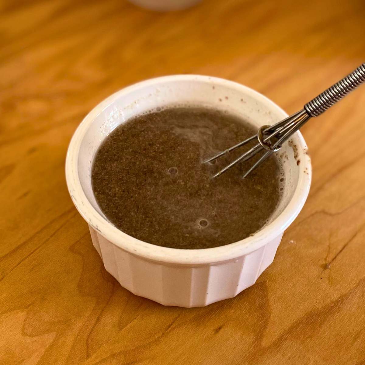 Ground flaxseed mixed with water in a small bowl.